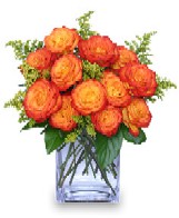 Sqaure vase of orange roses with goldenrod & leather leaf - meaning desire, enthusiasm