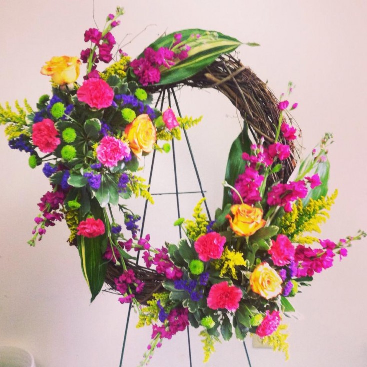 A vibrant sympathy wreath from Bev's Floral and Gifts in Parowan, UT