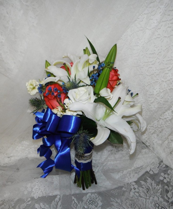 Stunning bouquet with coral, blue and white Oriental lilies from Crow River Floral and Gifts in Hutchinson, MN